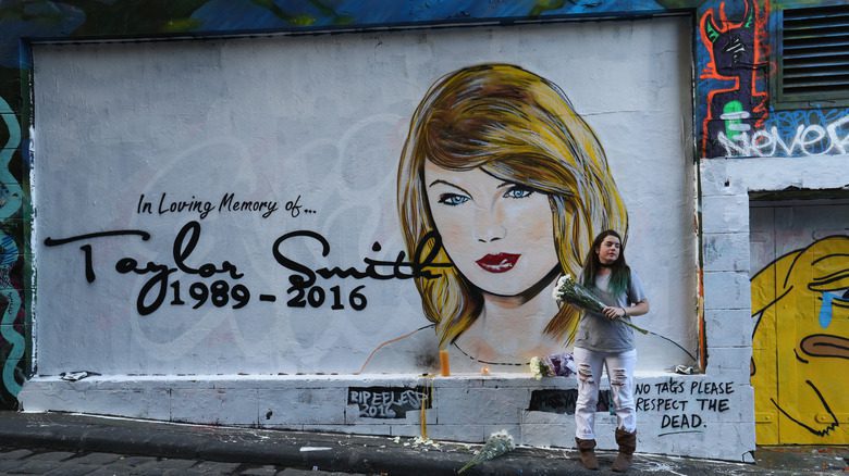 A mural of Taylor Swift with a 2016 death date