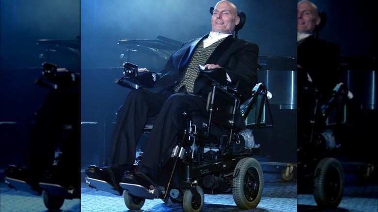 Christopher Reeve smiling suit wheelchair on stage