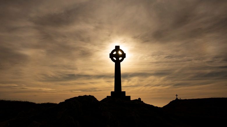 Celtic cross against setting sun
