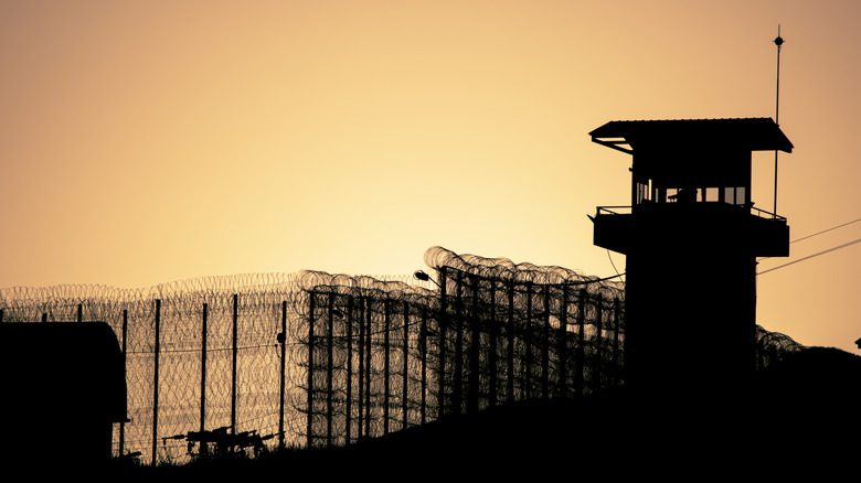Watchtower and prison wall at dawn