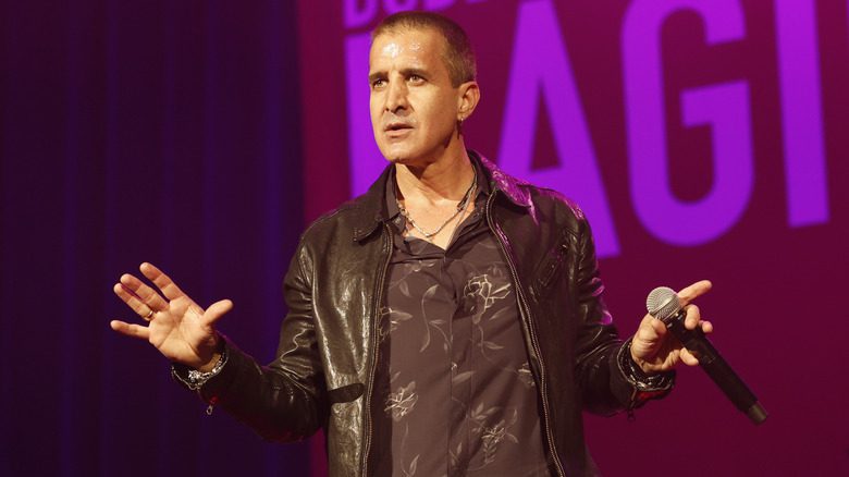 Scott Stapp gesturing while holding a microphone