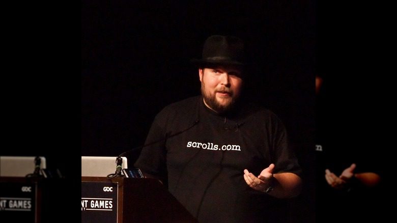 Markus Persson tout de noir vêtu avec un chapeau