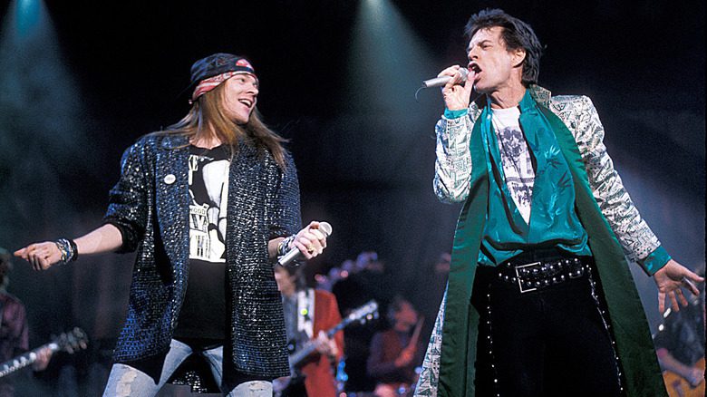 Axl Rose and Mick Jagger on stage singing