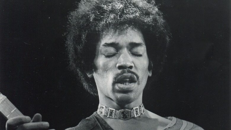 Jimi Hendrix on stage with guitar