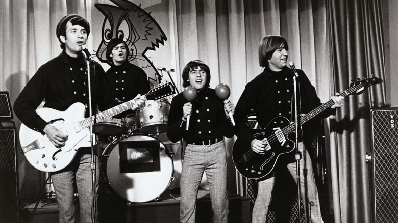 The Monkees with instruments on stage