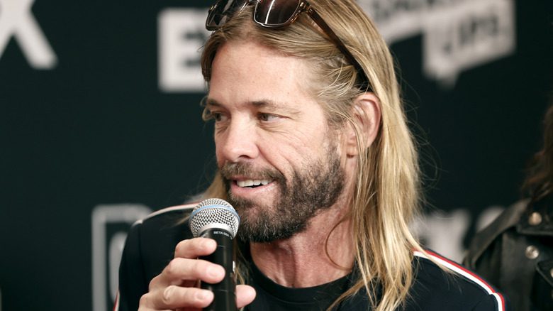 Taylor Hawkins speaking sunglasses microphone