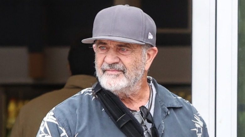 Mel Gibson avec une barbe grise et une casquette à l'extérieur