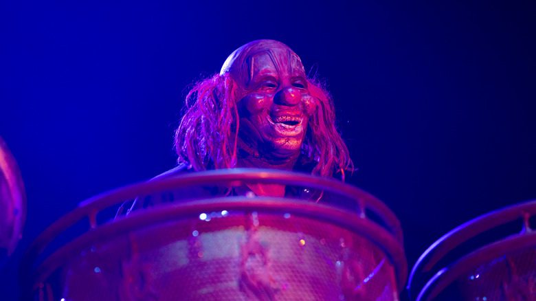 Clown peering over the drums