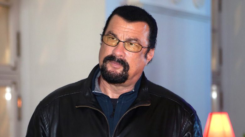 Steven Seagal glasses goatee black leather jacket