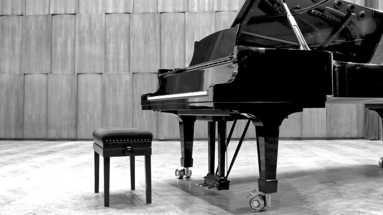 Grand piano set on stage, B&W