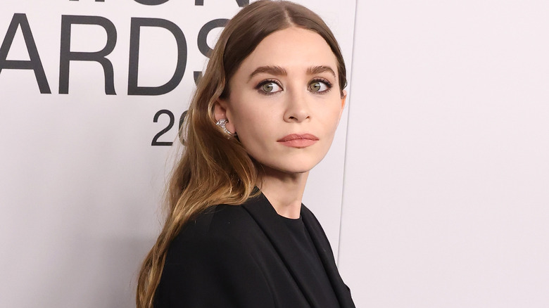 Ashley Olsen portant du noir et regardant sur le côté