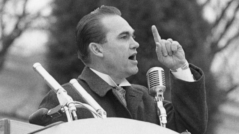 George Wallace speech finger raised podium outdoors