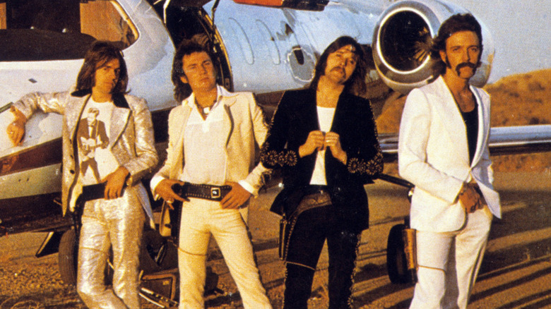 Foghat stands by a plane in 1970s publicity photo Gab Archive/Getty Images