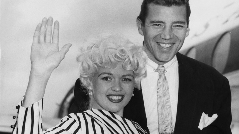 Jayne Mansfield waving with Mickey Hargitay next to her