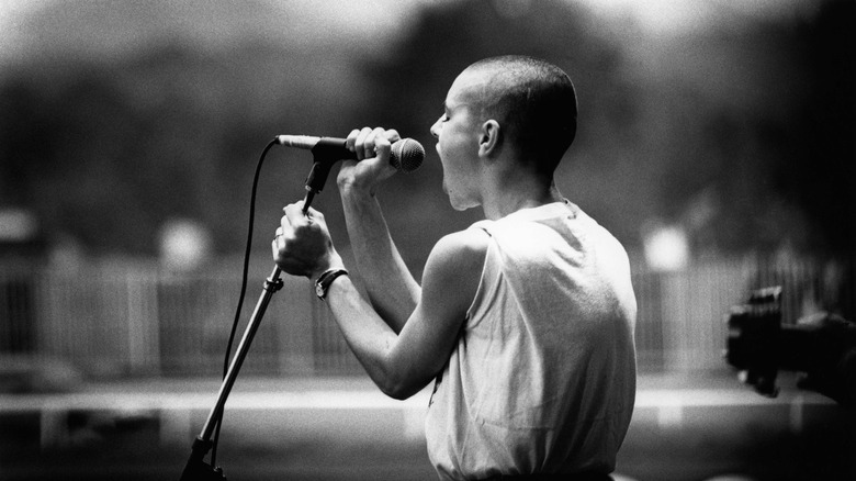 Sinead O'Connor singing into microphone