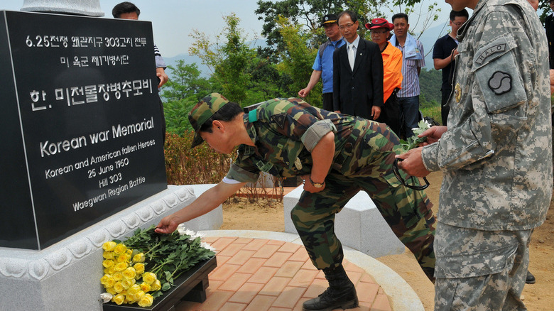 Soldiers of the US 501st Sustainment Brigade and South Korean Army troops rededicate the memorial on Hill 303