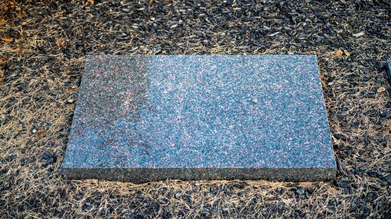 Unmarked headstone on ground