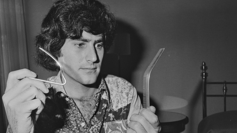 Uri Geller pliant une cuillère