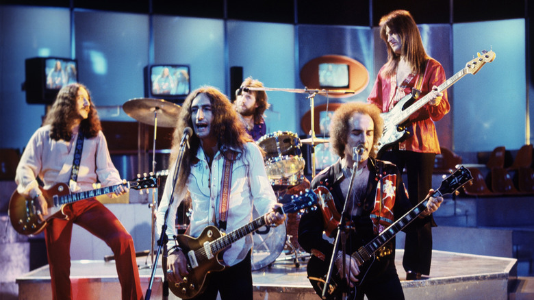 Uriah Heep performs on set adorned with TVs