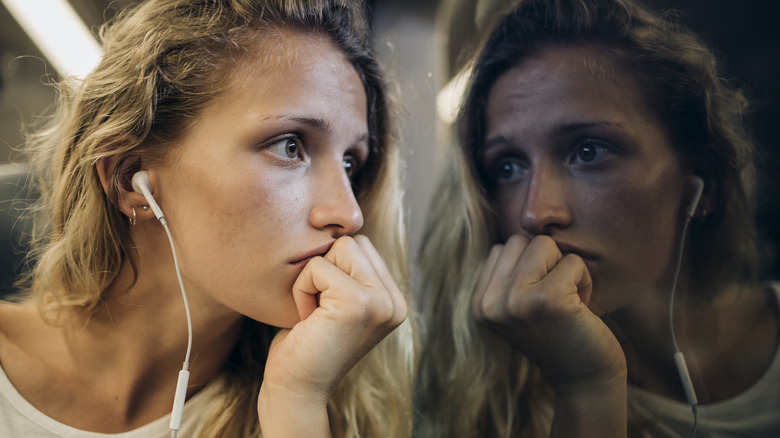 Anxious lady listening to headphones