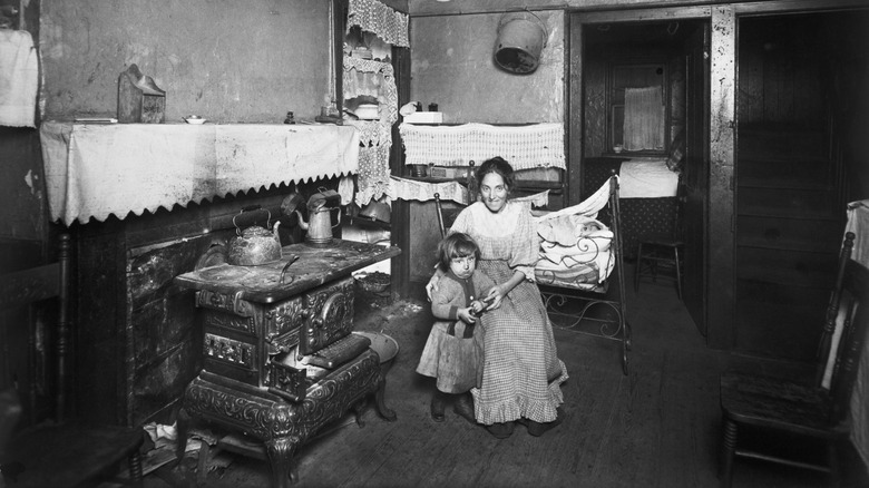 Une femme et un enfant dans un immeuble à New York vers 1910