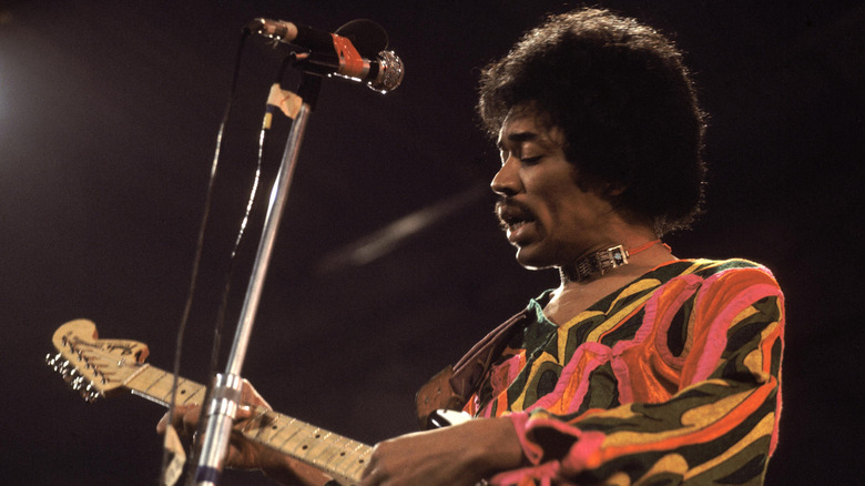 Jimi Hendrix playing guitar on stage