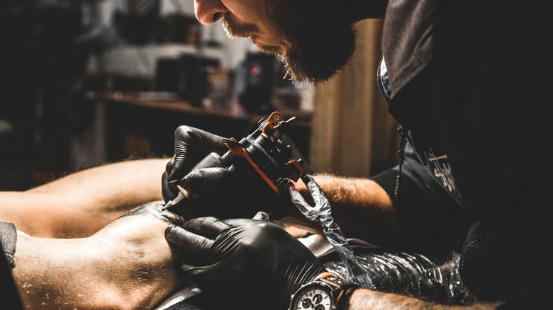 Artist mid tattoo