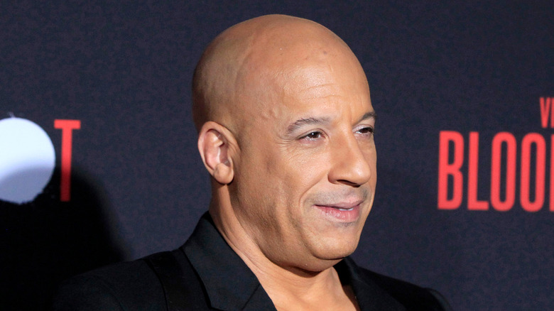 Vin Diesel black jacket smiling at event